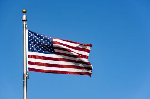 american_flag_waving_against_blue_sky_usa_flag_waving_scaled.thumb_.jpg